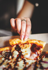 woman Hand takes a slice of chicken Pizza in paper box in cafe