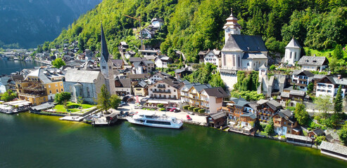 Fototapeta premium Hallstatt, Austria. Aerial view of the beautiful town from a flying drone over the lake in summer season.