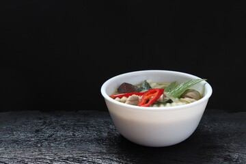 thai food chicken green curry on black background