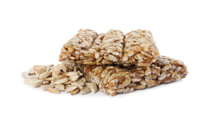 Delicious sweet kozinaki bars and sunflower seeds on white background