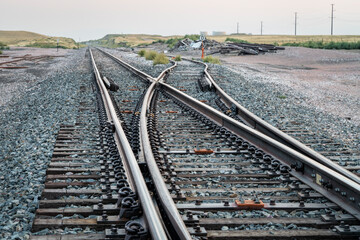 railroad tracks in a prairie of northern Colorado, late summer scenery with smoke and haze from...