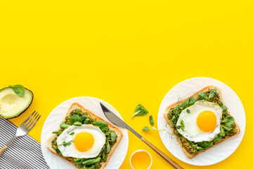 Open sandwich with avocado spinach cream and eggs. Top view