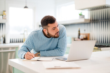 Fototapeta premium young man working on laptop at home 