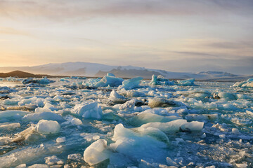 Beautiful sunset over famous Diamond beach, Ice floe on black sand Iceland beach. Jokursarlon,...