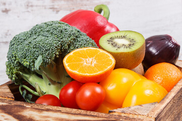 Heap of ripe fruits with vegetables in rustic box. Nutritious food containing healthy minerals and vitamins