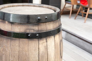 Fototapeta premium oak barrels light beige with a black hoop vertically on the background of a street cafe