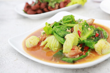 Stir Fried Cabbage with Crispy Pork in white dish favorite menu in Thailand resturant