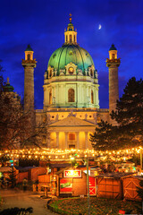 Festive cityscape - view of the Christmas Market on Karlsplatz (Charles' Square) and the Karlskirche (St. Charles Church) in the city of Vienna, Austria, 3 December, 2019