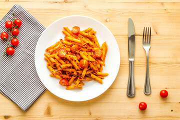 Cooked italian pasta in plate with tomato sauce and herbs