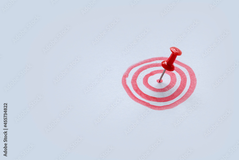 Poster selective focus the bullseye or bulls eye target or red dart circle with a red push pin on the cente