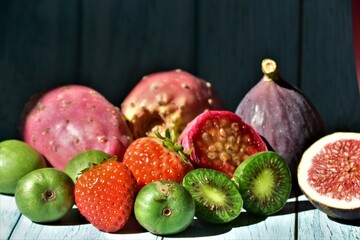 fresh eusotic berries on a blue wood table