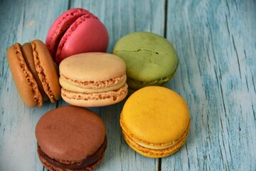 sweet macaron dessert on wood blue background