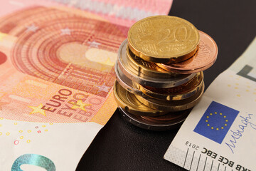 Euro currency. Euro coins and banknotes on the table. Soft focus