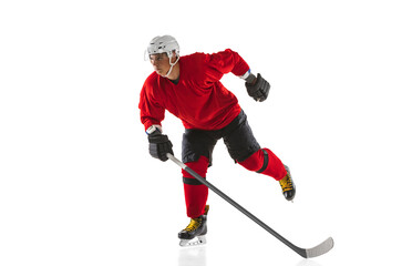 Full-length image of professional male hockey player training isolated over white background