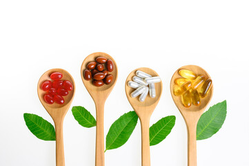 Alternative medicine, pills tablet, capsule and vitamin organic supplements good for health in wood spoon on white background with copy space, medicine and drug concept