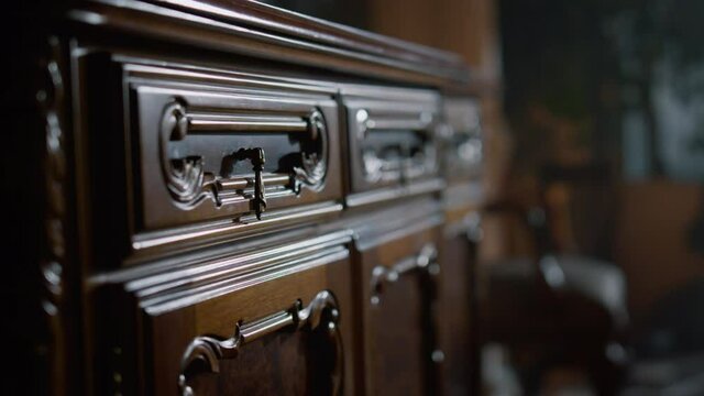 Wooden chest drawers in colonial interior. Vintage commode with carving indoors.