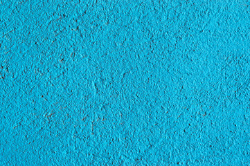 pared pintada con fondo azul turquesa y textura rugosa