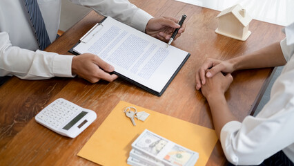 Real estate agent and customer signing contract to buy house, insurance or loan real estate.