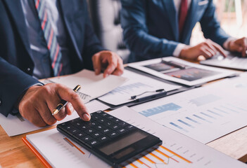 Business Consulting meeting working, two business people talking, brainstorming to making a profit of company planning to analyze investment and marketing business strategy projection table in office.