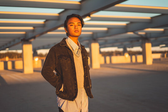 Man in dark jacket standing outdoor during golden hours