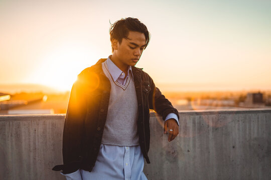 Man in dark jacket standing outdoor during golden hours