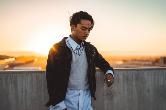 Man in dark jacket standing outdoor during golden hours