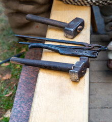 blacksmith's tool horseshoe hammer, tongs on the table