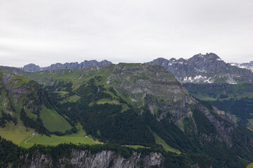 Naklejka premium Amazing hiking day in the hearth of Switzerland. Wonderful scenery while climbing the summit and watching over the alps. Epic landscape.