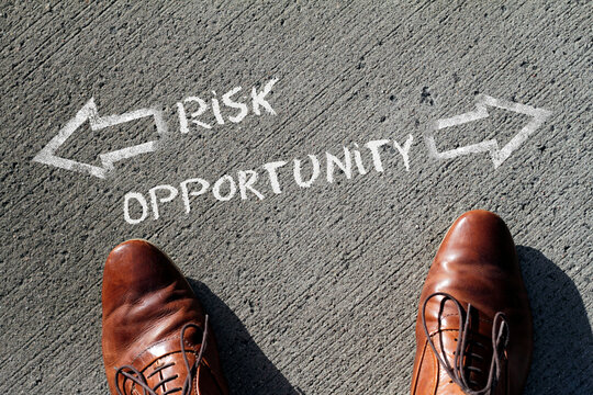 Risk vs Opportunity drawn in chalk on a sidewalk