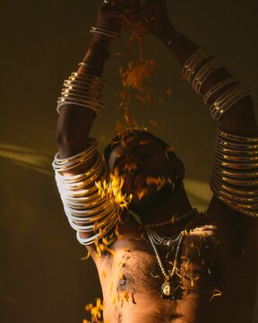 Topless man wearing Indian jewelries and dancing