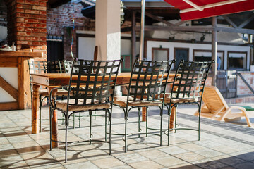 wooden table and chairs on the pool terrace. garden furniture 
