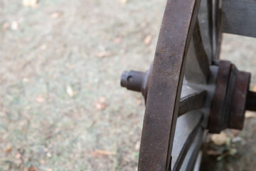 iron wheel of a van old and rusty close-up on the background of the ground