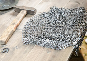 chain mail armor protection of a warrior production from rings on a wooden background