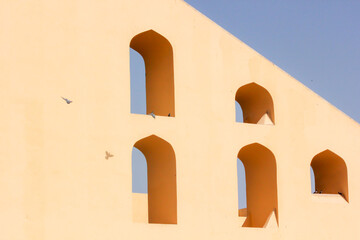 The abstract geometric patterns of the arched windows of the ancient astronomical observatory of...