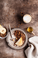 Chocolate granola with almond milk, pear and honey.
