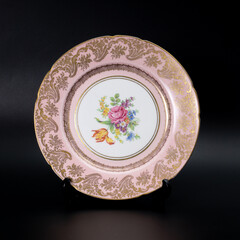 Antique english porcelain plate on a black background