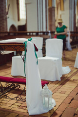 Church sanctuary before a wedding ceremony. Empty chairs for bride and groom.