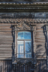 A beautiful building from the beginning of the 19th century, decorated with carved wood. Living conditions in the old town. Country house on a summer day.