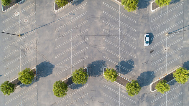 Single Car Working Its Way Through The Parking Lot To Park