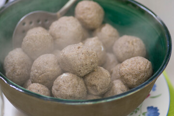 A bowl of Matzah balls, or matzo balls, Ashkenazi Jewish soup dumplings, traditionally eaten in the Jewish holiday of  Passover 
