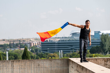 Hip-hop dancer holding colombian flag in rooftop