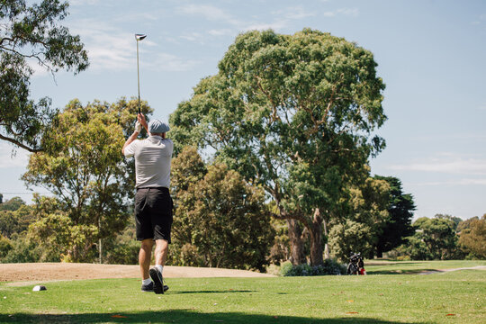 Male Golfer Hitting A Ball