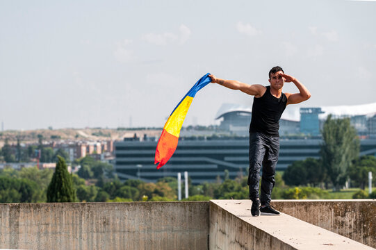 Bipoc dancer holding colombian flag in rooftop