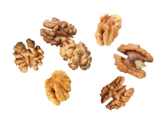 Halves of walnuts falling on white background