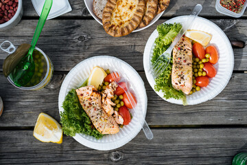 Fish with salad served on picnic table