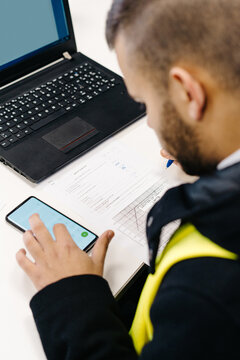 Crop pilot examining  flight path on laptop