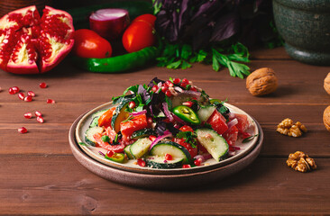 Traditional Georgian salad, Fresh vegetables, with walnut dressing, spices, herbs, pomegranate seeds, horizontal, no people,