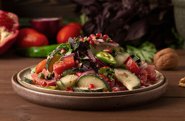 Traditional Georgian salad, Fresh vegetables, with walnut dressing, spices, herbs, pomegranate seeds, horizontal, no people,