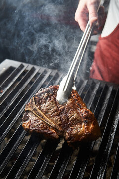 Chef preparing grilled meat steak