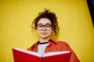 Calm woman with book doing homework